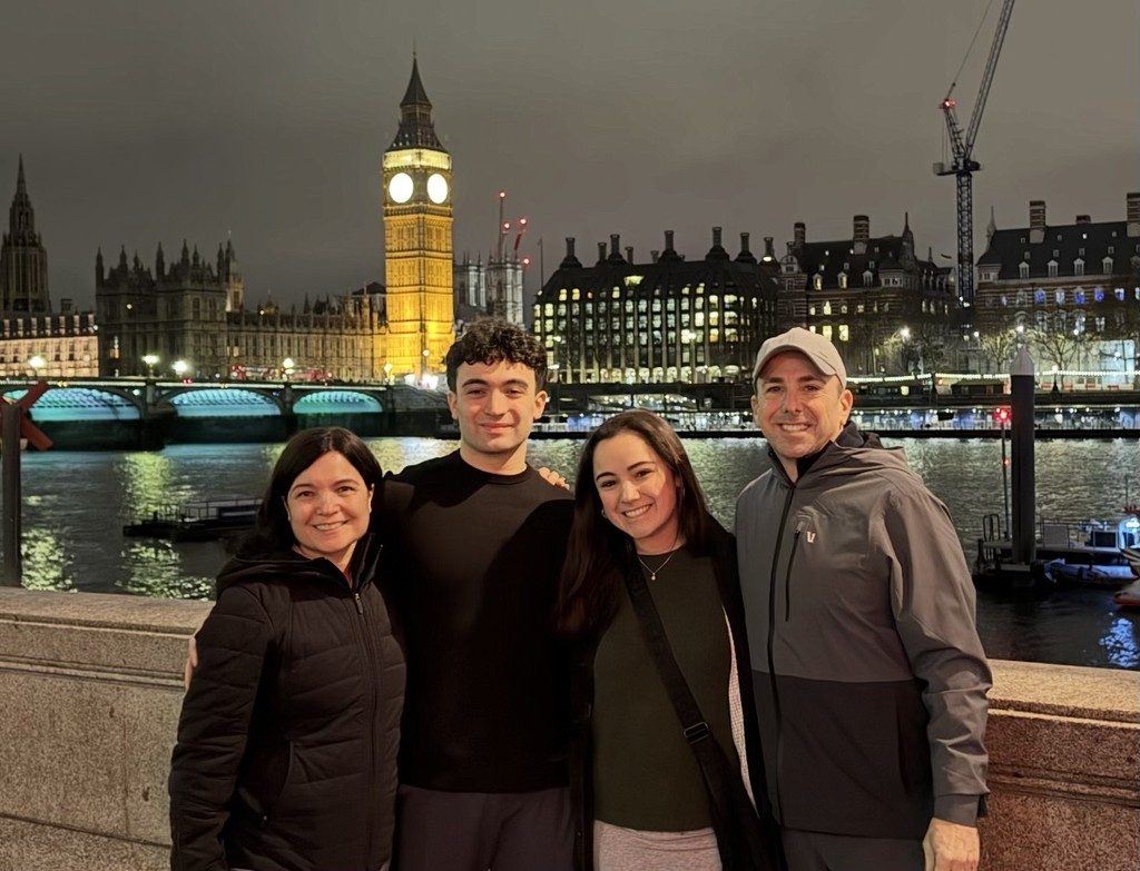 Peter and family by the Thames at night, Big Ben behind them
